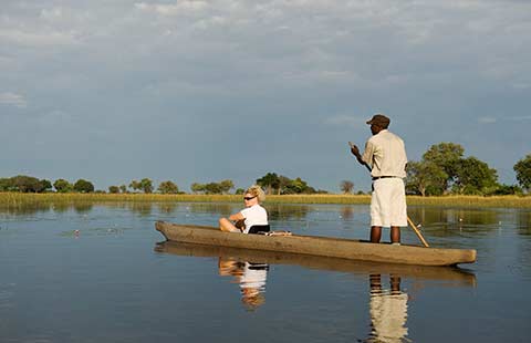 Visitor on mokoro trip in the Okavango Delta, Botswana